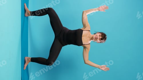Preview: Vertical video: Athlete stretching muscles after physical training on yoga mat