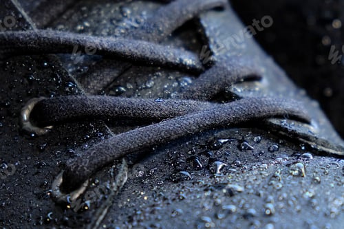 Preview: close-up details waterproof men's black boots. Drops of rain on suede shoes.