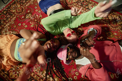 Preview: Young People Lying on Carpet in Circle