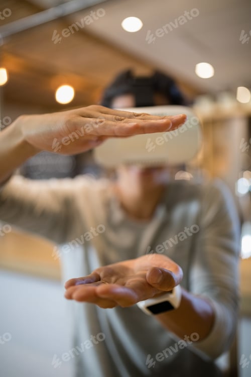Preview: Man using virtual reality headset in restaurant