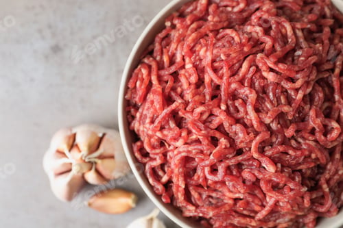 Preview: Fresh raw minced meat on light table, closeup