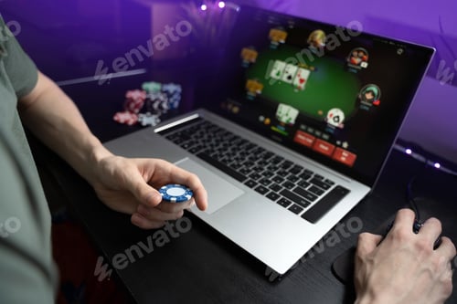 Preview: Young man play online poker in laptop.