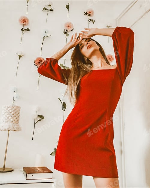 Preview: Woman in Red Dress Posing With Flowers