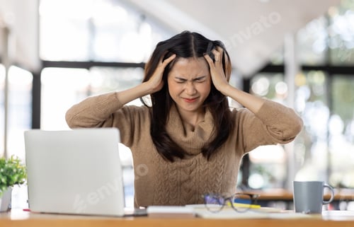 Preview: Tired Young freelance asian business woman headache Sad feeling sick at the workplace office,unhappy