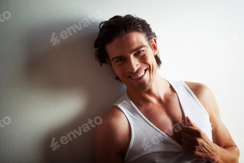 Smiling Man Leaning Against a Textured Wall