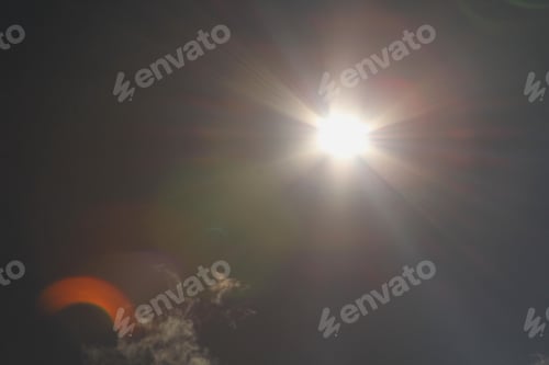 Preview: Partial Solar Eclipse - Photograph Of The Sun While Partially Covered By The Moon. Lens Flares Show