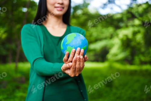 Preview: A male hand holds a hammer, symbolizing the enforcement of tree conservation laws. This highlights