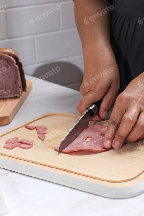 Preview: Asian Chef Female Hand Sliced Smoked Beef into Small Pieces. Cooking Process in the Kitchen
