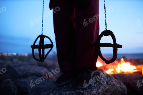 Preview: Man holding flaming chains outdoors