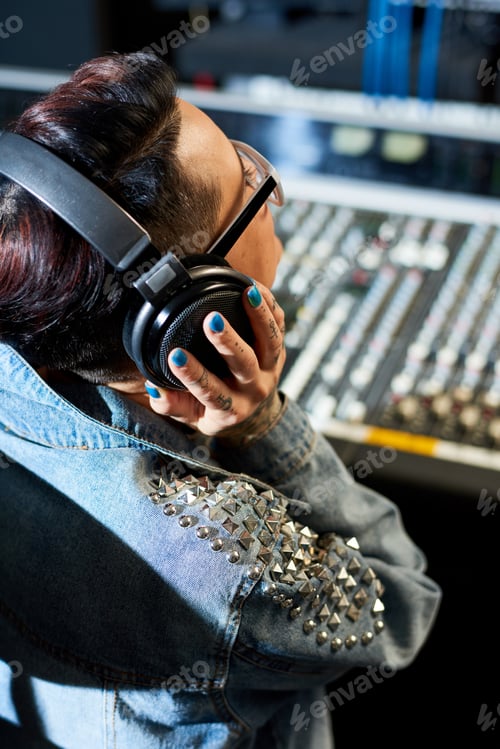 Preview: Producer listening to audio track in studio