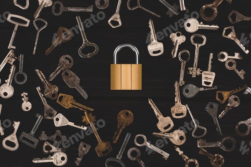 Preview: top view of different metal keys with lock on black table