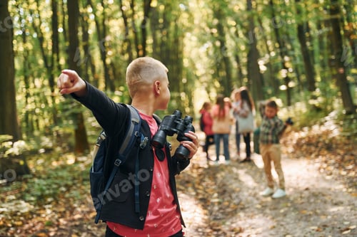 Preview: Founding the way. Kids in green forest at summer daytime together
