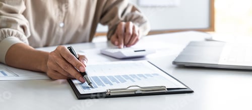 Preview: business woman working and analyzing on laptop with calculate statistics of financial document data
