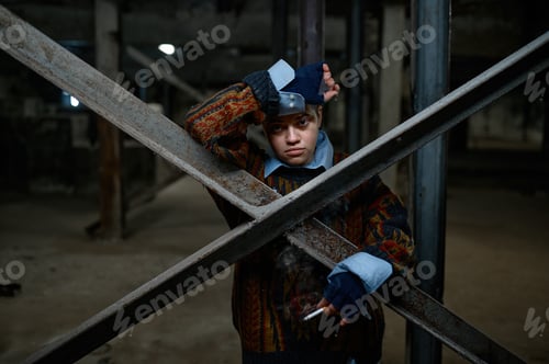 Preview: Portrait of teenage hipster girl refugee or beggar in abandoned building