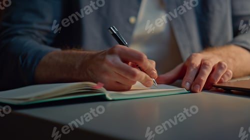 Preview: Man hands writing notebook at late office closeup. Anonymous guy making notes