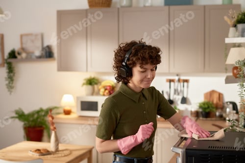 Preview: Housewife wiping dust in the kitchen