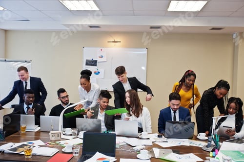 Preview: Multiracial young creative people in modern office