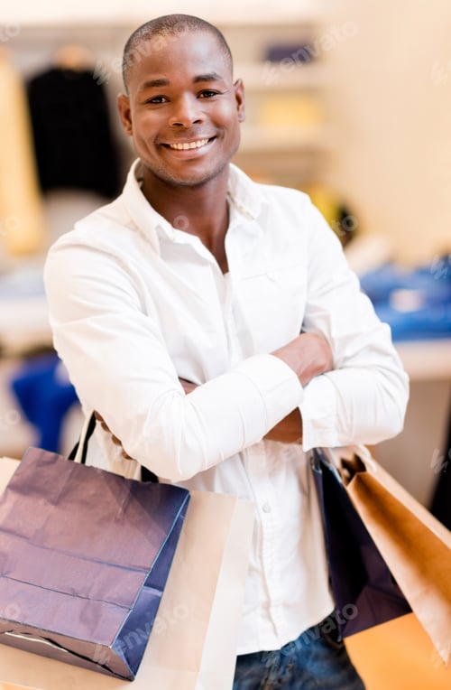 Preview: Happy Shopping Man Holding Bag At The Mall And Smiling
