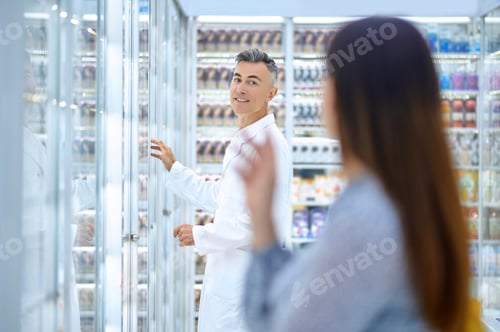 Preview: Pharmacy customer asking a professional druggist for medical advice
