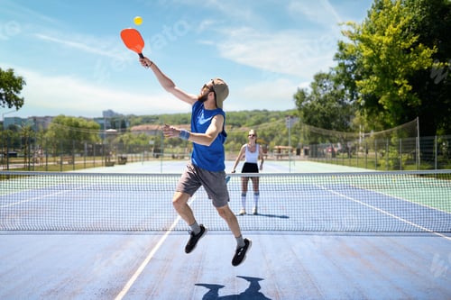 Preview: Couple playing pickleball outdoor at daylight