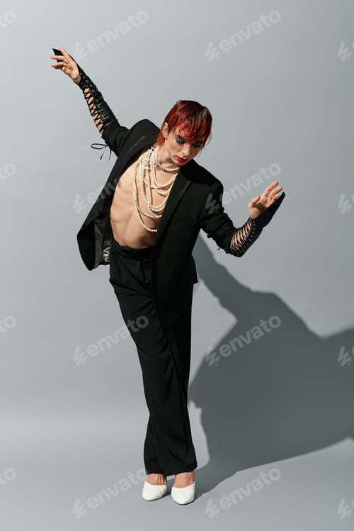Preview: A striking young man in a bold outfit strikes an artistic pose, radiating confidence and flair.