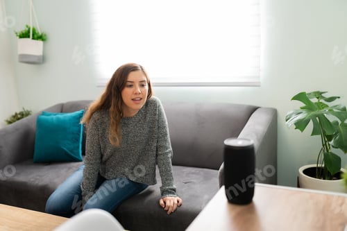 Preview: Young woman speaking a command to her smart device