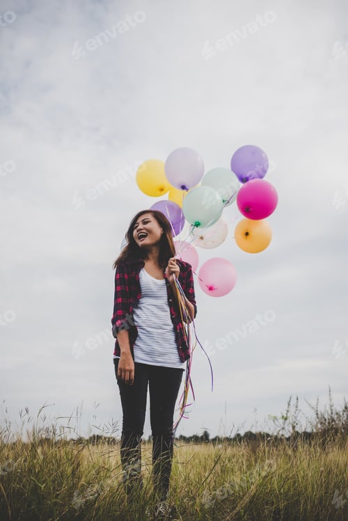 Preview: Beautiful young hipster woman holding with colorful of balloons outdoor, Freedom enjoy with nature.