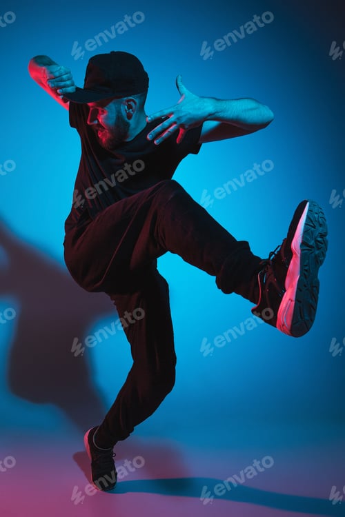 Preview: The silhouette of one hip hop male break dancer dancing on colorful background