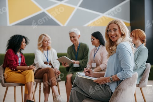 Preview: Happy mature woman looking at camera while visiting group training class for females