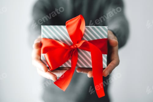 Preview: Giving a Gift with Red Bow Close Up