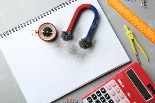 Preview: Notebook, compass and magnet with iron powder on table, flat lay composition. Space for text