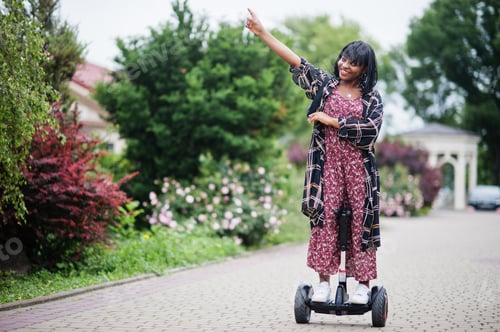 Preview: African american woman using segway or hoverboard