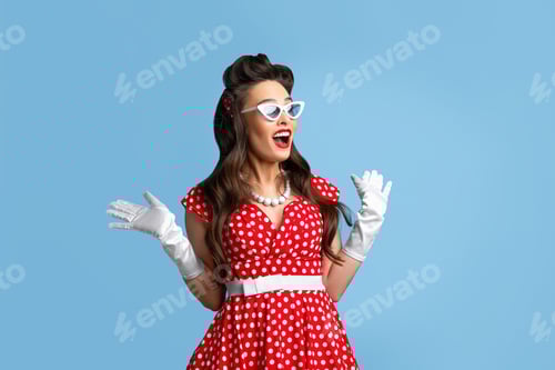 Preview: Stylish pin up woman in polka dot red dress and sunglasses feeling excited, opening mouth in shock
