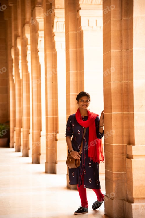 Preview: Indian woman standing between arches and Pillars.