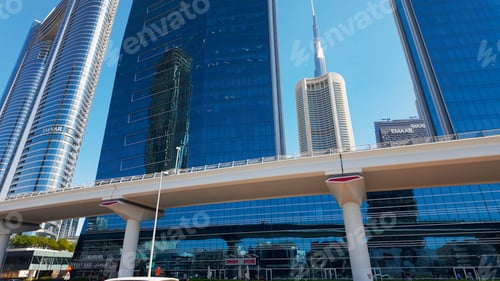 Preview: Dubai city with street and bridge with driving cars. Action. Clear blue sky and skyscrapers of the
