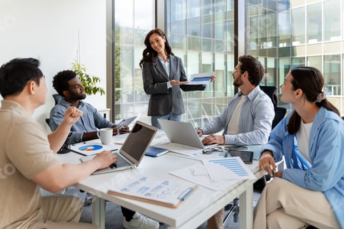 Preview: Businesswoman showing infographic to colleagues during a meeting