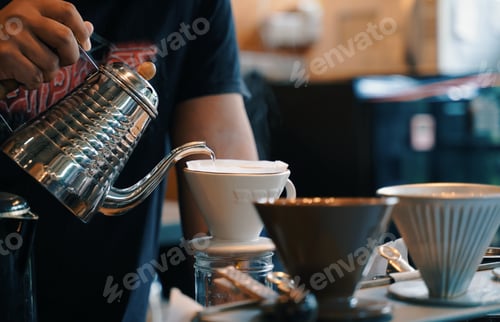 Preview: A man making coffee with drip coffee