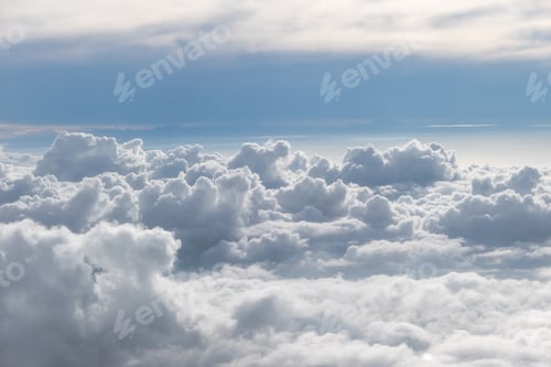 Preview: Above fluffy clouds with blue sky from airplane