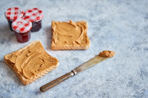 Preview: Two tasty peanut butter toasts placed on stone table