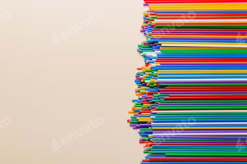 Preview: Heap of colorful plastic drinking straws on Colored background, flat lay. Copy Space for text