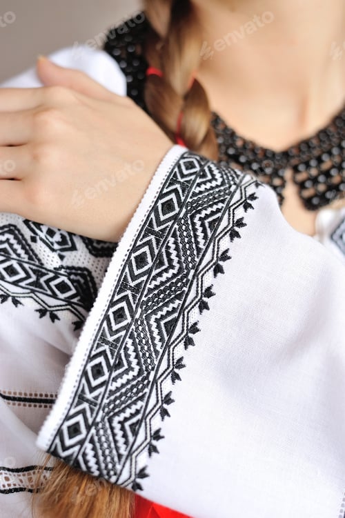 Preview: The girl in an embroidered shirt. Closeup pattern on the sleeve.