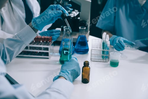 Preview: Science and medicine, scientist analyzing and dropping a sample into a glassware