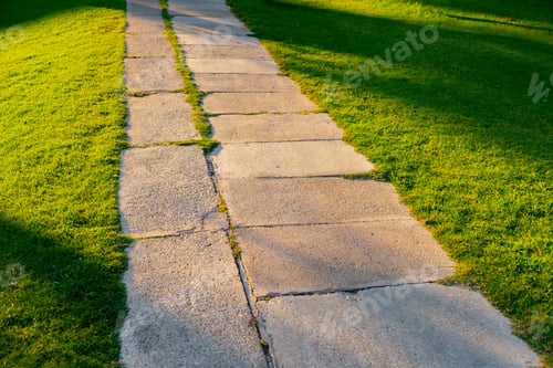Preview: Stone footpath on a green grass in the park
