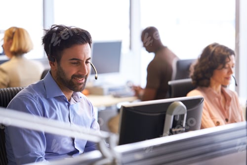 Preview: Businessman Wearing Telephone Headset Talking To Caller In Customer Services Department