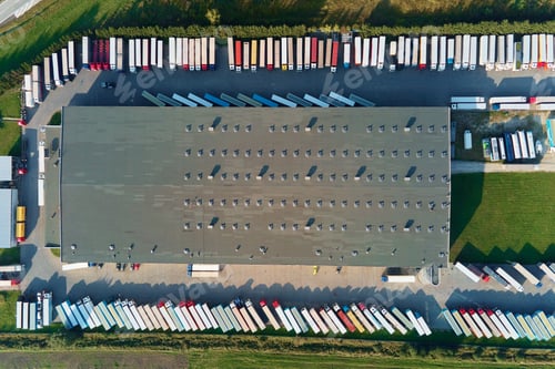 Preview: Factory warehouse with parked semi trucks, aerial view