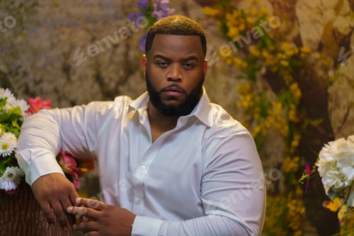 Preview: African American man in a white shirt posing for a photo