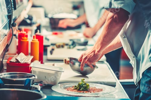 Preview: Two chefs in uniform preparing delicious dish