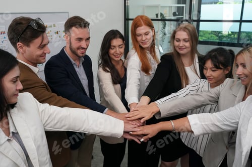 Preview: Team members collaborating in a modern office, celebrating success with a group gesture
