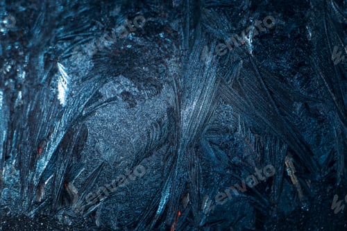 Preview: Frosty patterns on glass. Christmas background. Blue ice on winter window. Abstract texture