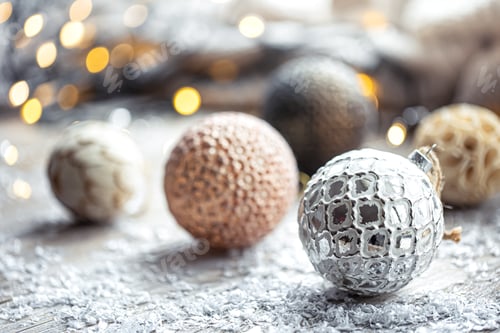 Preview: Festive background with Christmas balls and blurred bokeh lights.